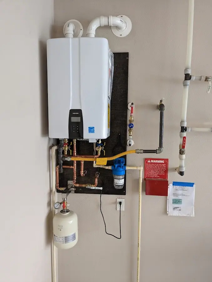 Professional plumber installing copper piping in a Oceanside home